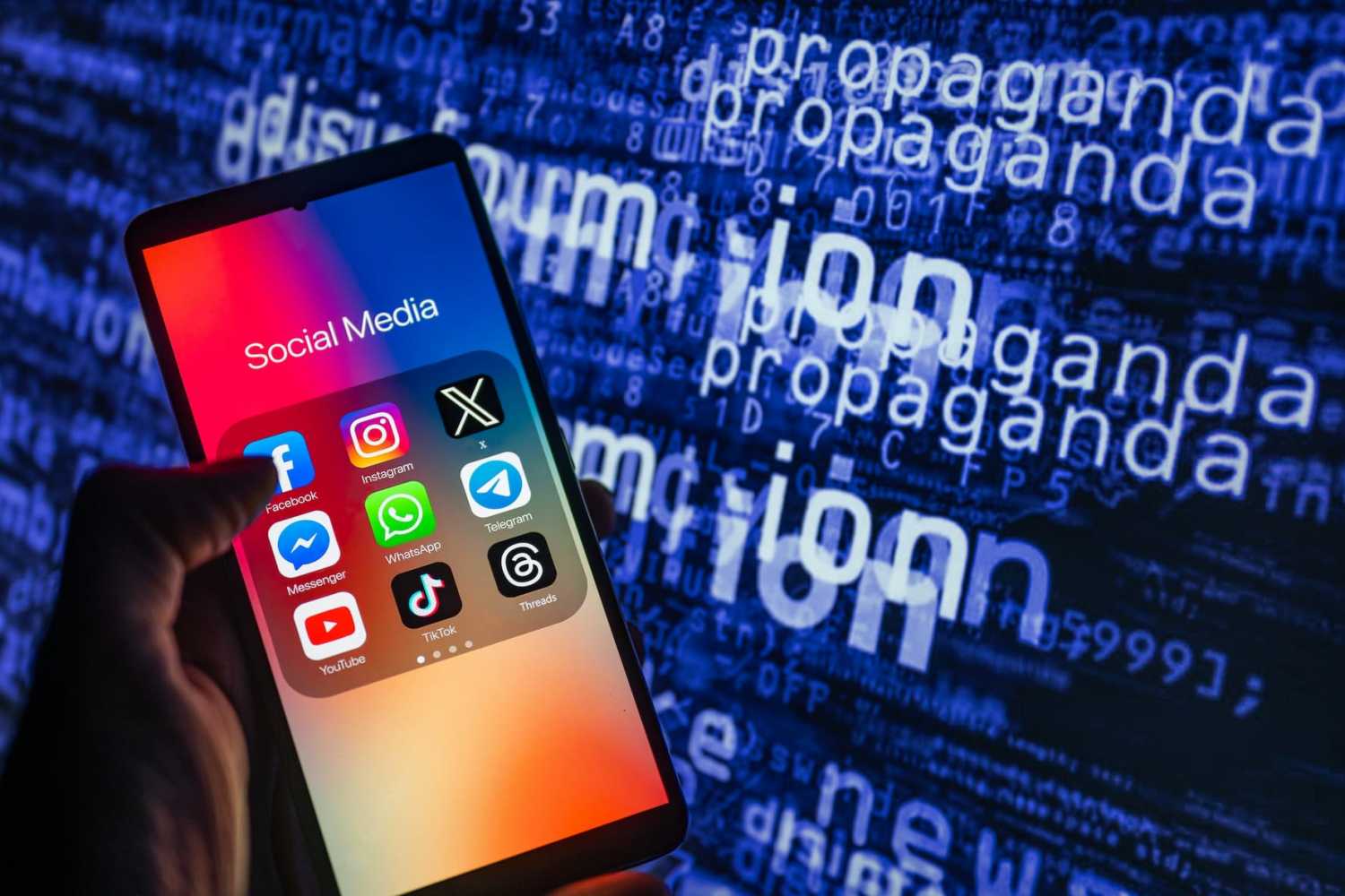 Social media icons logo displayed on a smartphone with disinformation on screen seen in the background of this photo illustration taken on October, 15 2023.