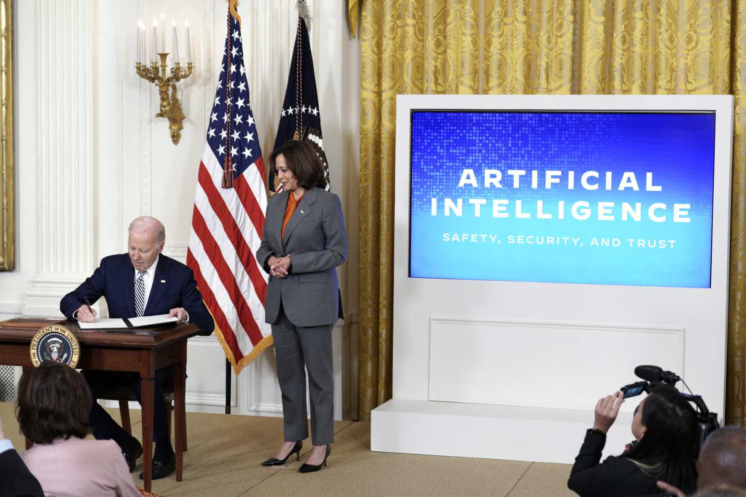 U.S. President Joe Biden with Vice President Kamala Harris signs an executive order during the artificial intelligence event at the White House in Washington on October 30, 2023.