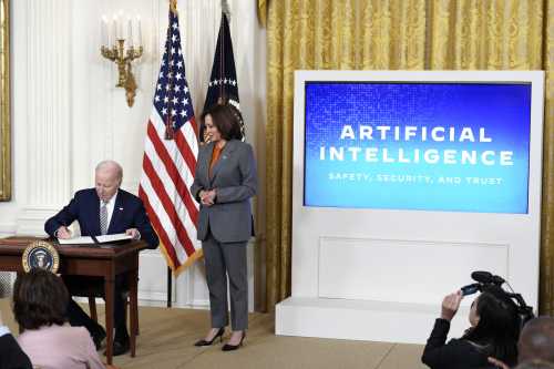 U.S. President Joe Biden with Vice President Kamala Harris signs an executive order during the artificial intelligence event at the White House in Washington on October 30, 2023.