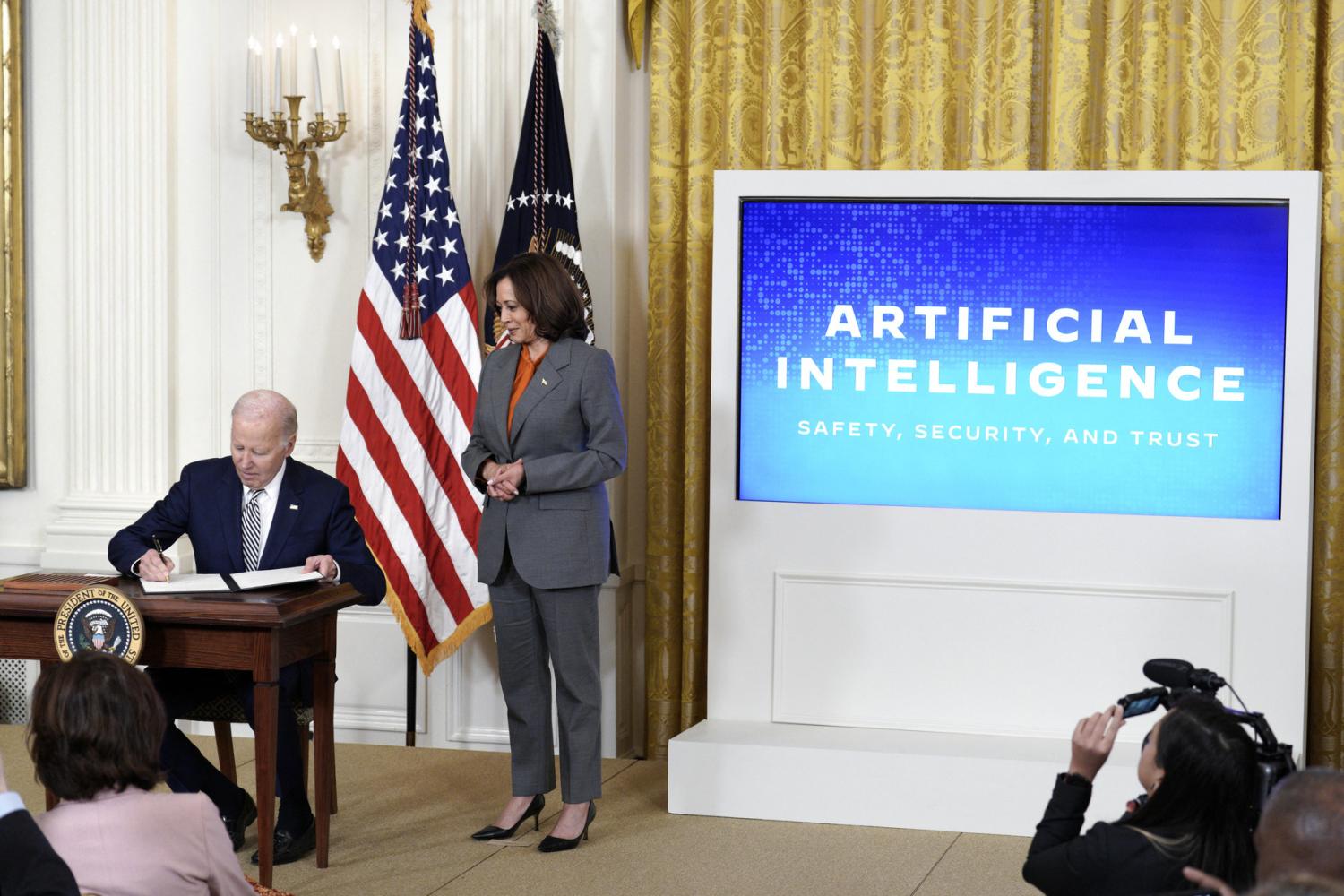 U.S. President Joe Biden with Vice President Kamala Harris signs an executive order during the artificial intelligence event at the White House in Washington on October 30, 2023.