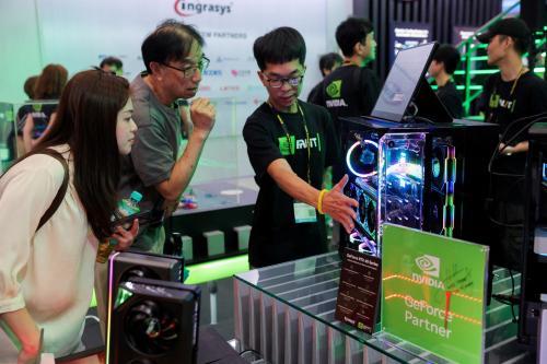 Staff introduce NVIDIA GeForce series equipment on display at Computex in Taipei, Taiwan June 5, 2024.