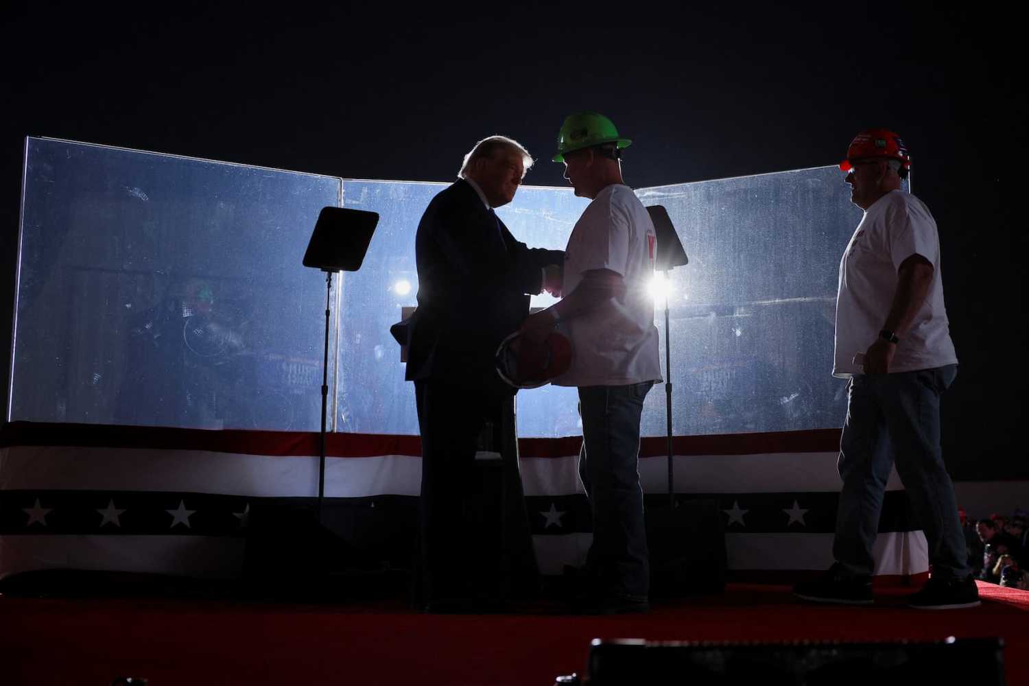 Steel workers walk onstage and endorse Republican presidential nominee and former U.S. President Donald Trump during his Make America Great Again Rally in Latrobe, Pennsylvania, U.S. October 19, 2024. REUTERS/Brian Snyder
