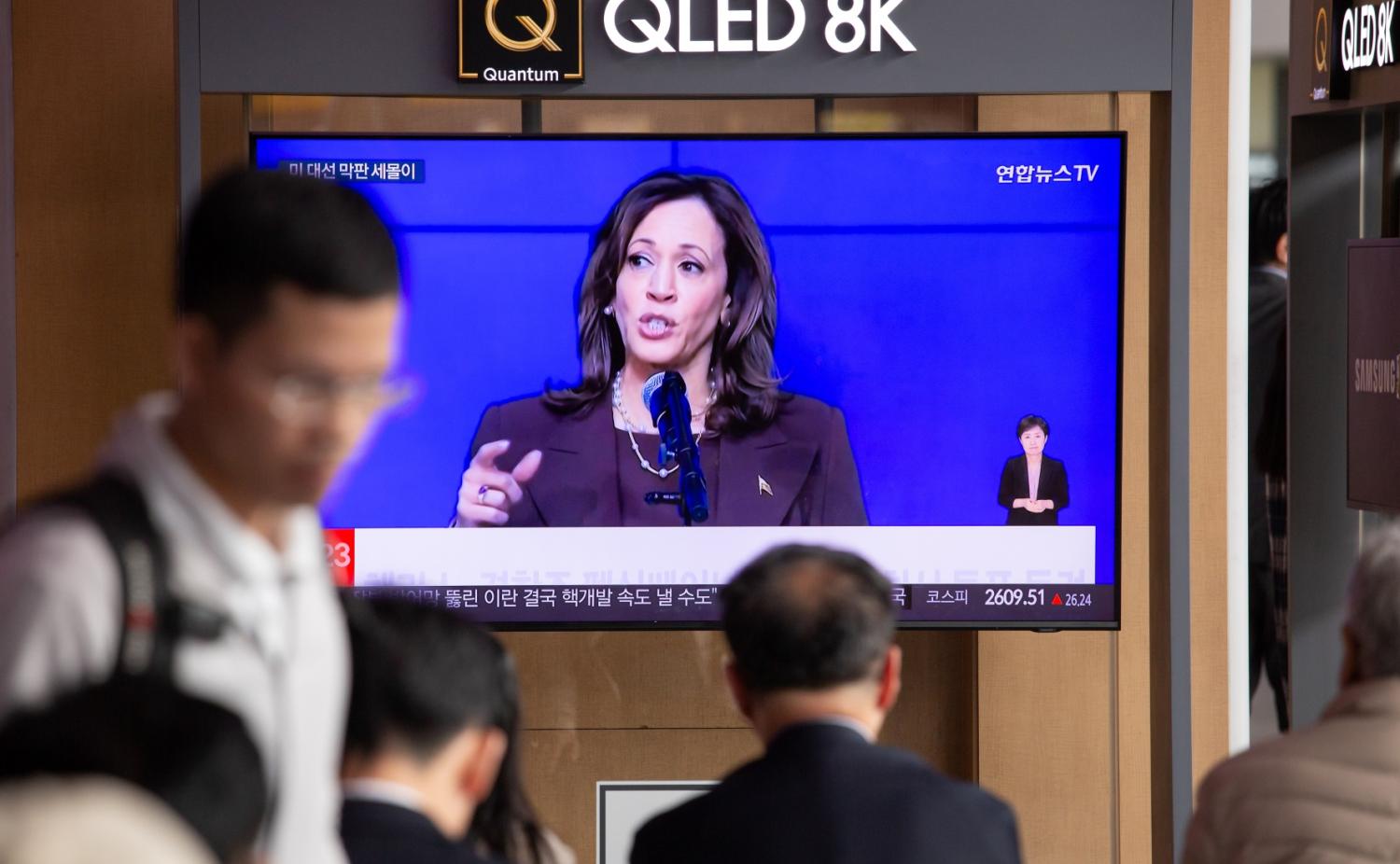 A TV screen shows a news report on the U.S. presidential election between Democratic standard-bearer Kamala Harris and her Republican rival Donald Trump, at a train station in Seoul, South Korea.