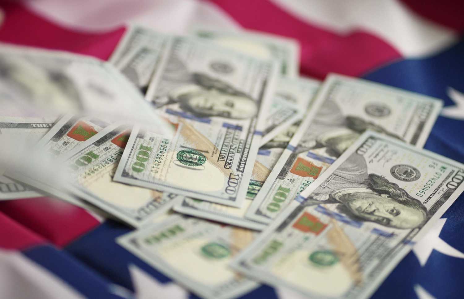 Stack of $100 bills on an American flag