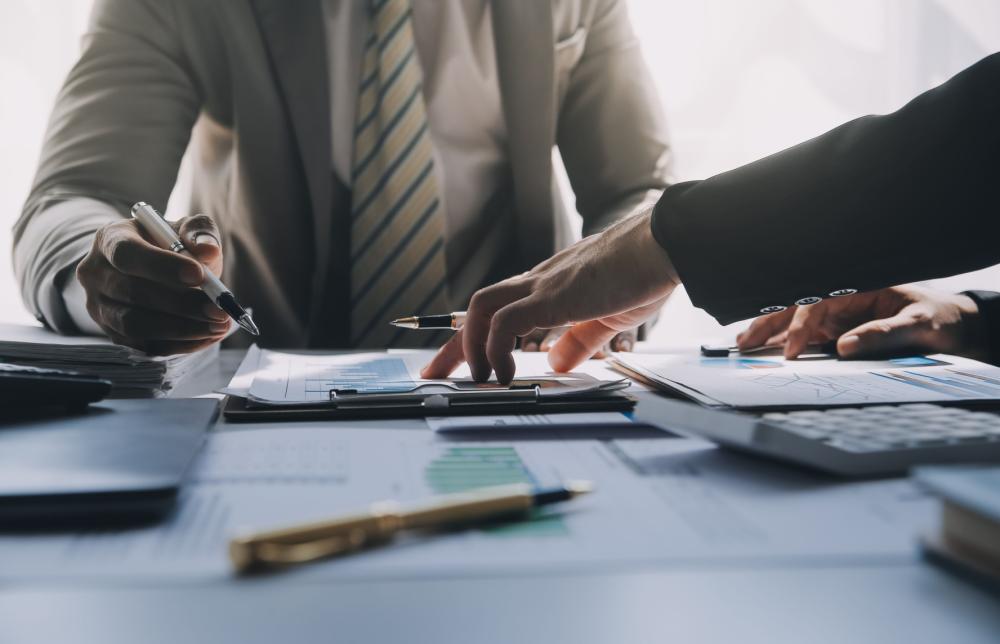 Two businessmen having a meeting over financial documents.