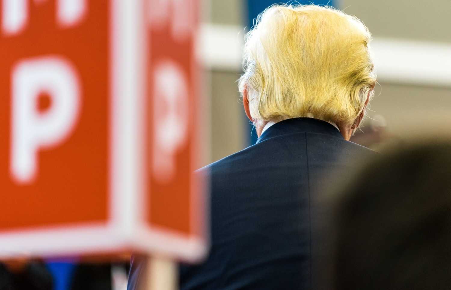 Donald Trump at a campaign event from behind.