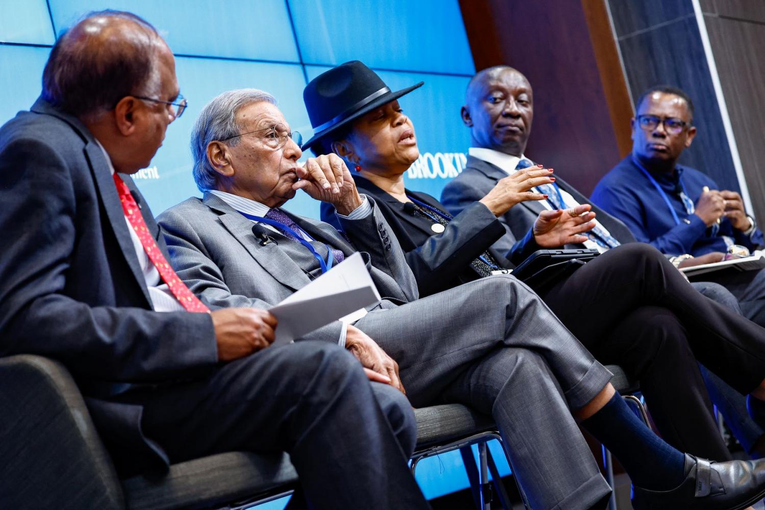 Panelists sit on stage