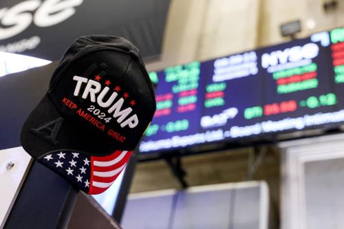 A hat reading "Trump 2024" hangs in front of a stock ticker