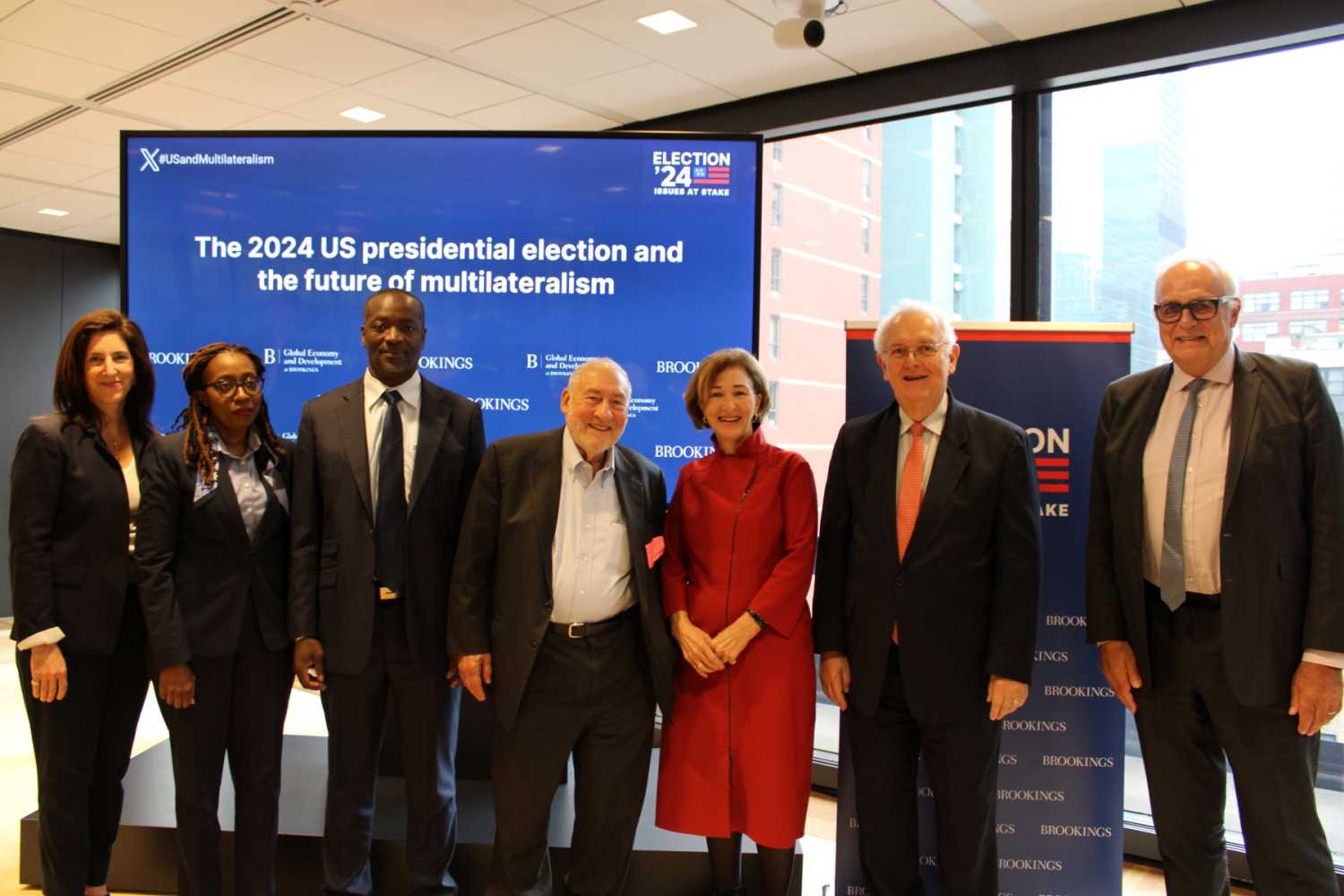 Panelists stand in front of a display reading "US elections and the future of multilateralism"
