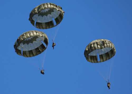 Troops from Japan's Ground Self-Defense Force 1st Airborne Brigade parachute from U.S. Air Force 374th Airlift Wing's C-130J aircraft during a New Year joint military drill among Japan, U.S., Britain and Australia at Narashino exercise field in Funabashi, east of Tokyo, Japan January 8, 2023.