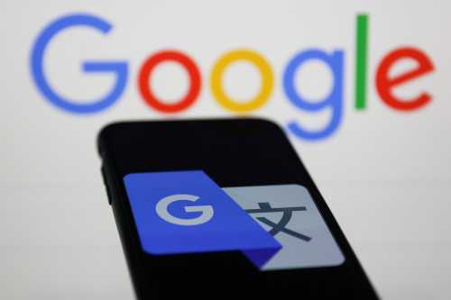 Google Translate icon displayed on a phone screen and Google logo displayed in the background are seen in this illustration photo taken on February 8, 2023.