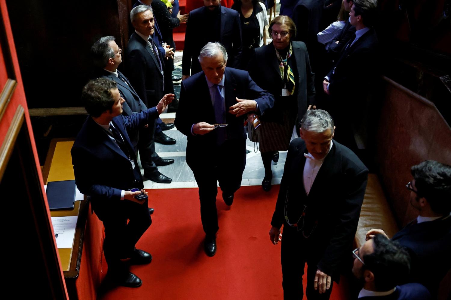 French Prime Minister Michel Barnier leaves after the result of the vote on the first motion of no-confidence against the French government, tabled by the alliance of left-wing parties the New Popular Front at the National Assembly in Paris, France, December 4, 2024.