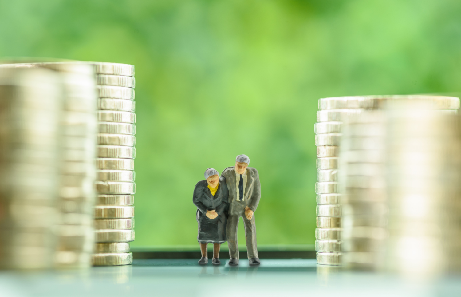 An older couple walking next to piles of coins