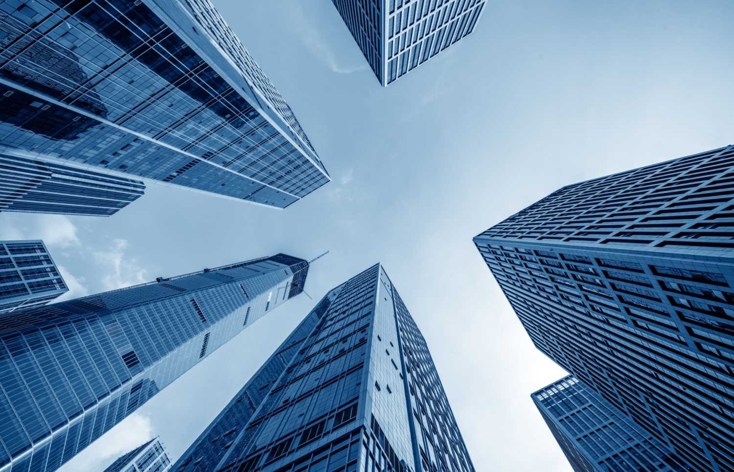 Image looking up at large corporate skyscrapers from below.