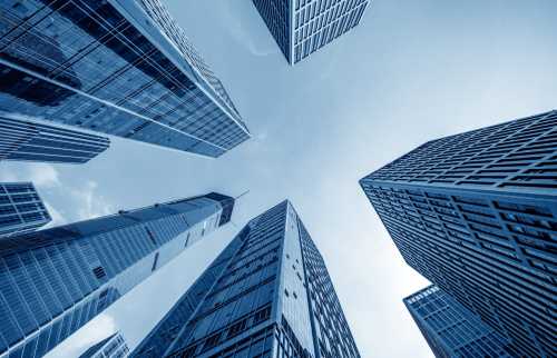 Image looking up at large corporate skyscrapers from below.