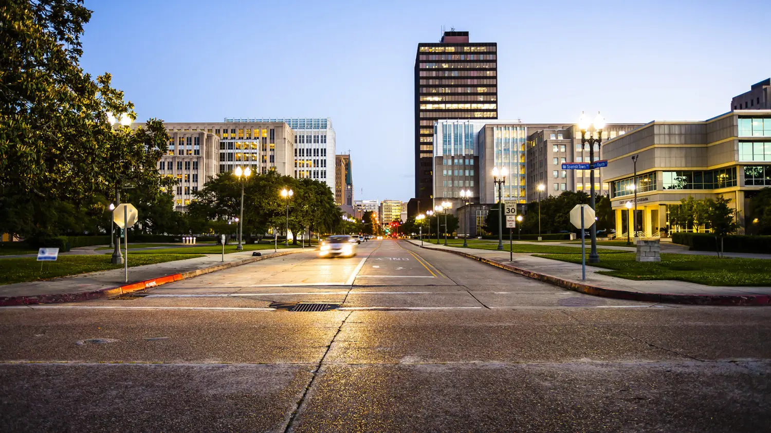 Street in downtown Baton Rouge, Louisiana as night falls - skyline