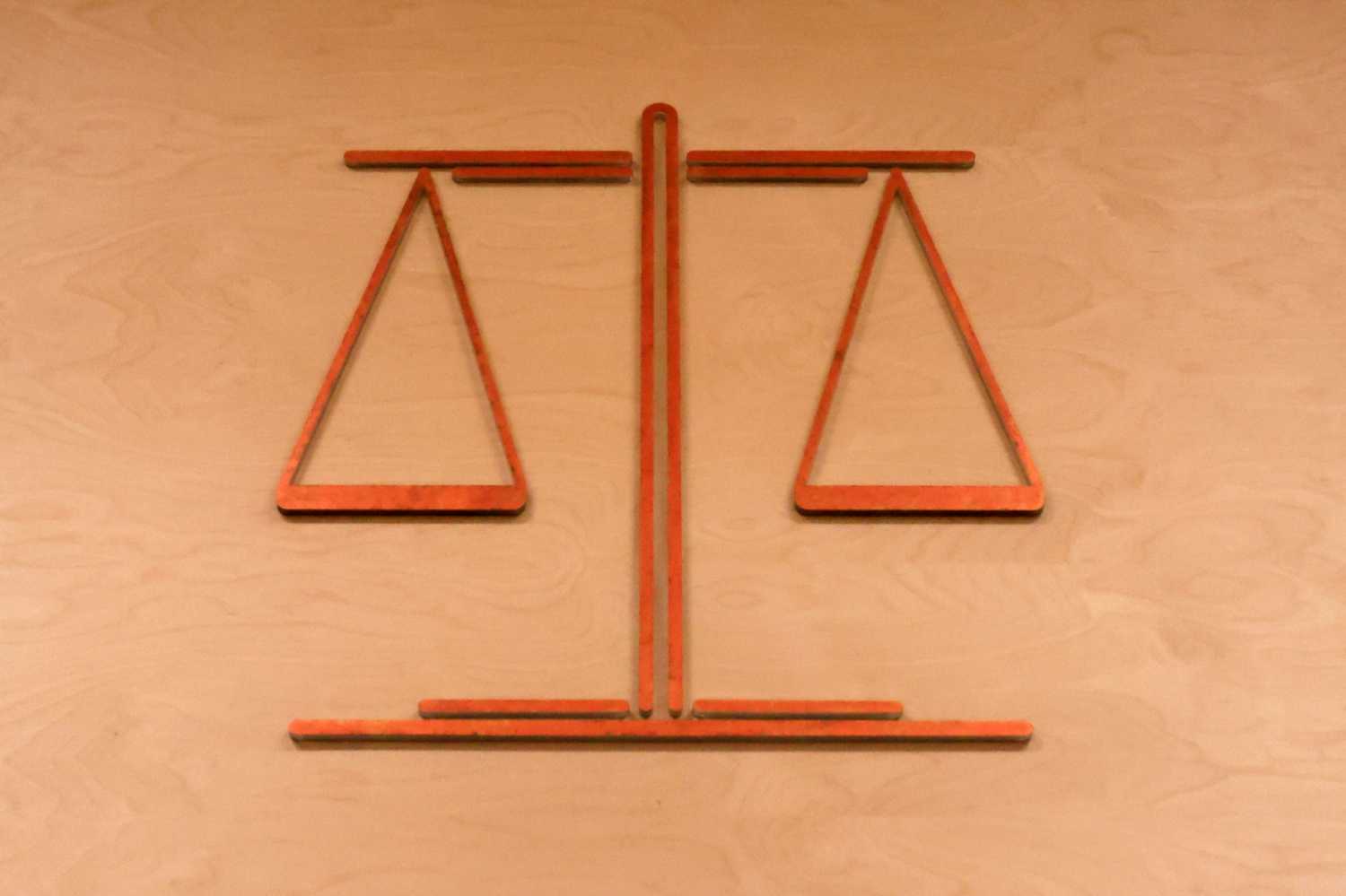 A photo depiction of the scales of justice, the symbol of law and justice, carries historical parallels with how drugs used to be weighed.
