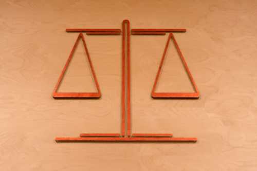A photo depiction of the scales of justice, the symbol of law and justice, carries historical parallels with how drugs used to be weighed.