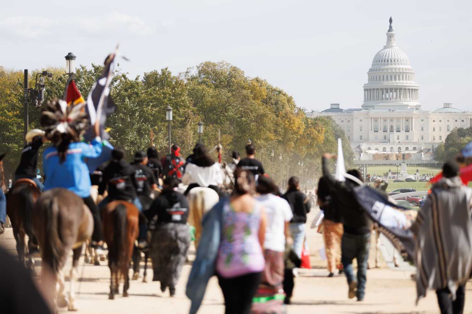 Members of the Muwekma Ohlone Tribe of the San Francisco Bay Area, along with other tribal groups and their supporters, march along the National Mall in Washington, D.C. on horseback on Indigenous Peoples' Day, October 14, 2024. The demonstrators rode across the country on horseback as part of the protest titled the "Trail of Truth," arriving in Capitol Hill to demand federal recognition for Indigenous tribes.