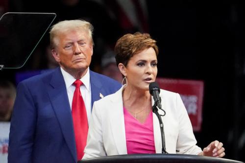Republican presidential nominee and former U.S. President Donald Trump looks on as nominee for U.S. Senate in Arizona Kari Lake speaks during a campaign rally in Prescott Valley, Arizona, U.S., October 13, 2024.