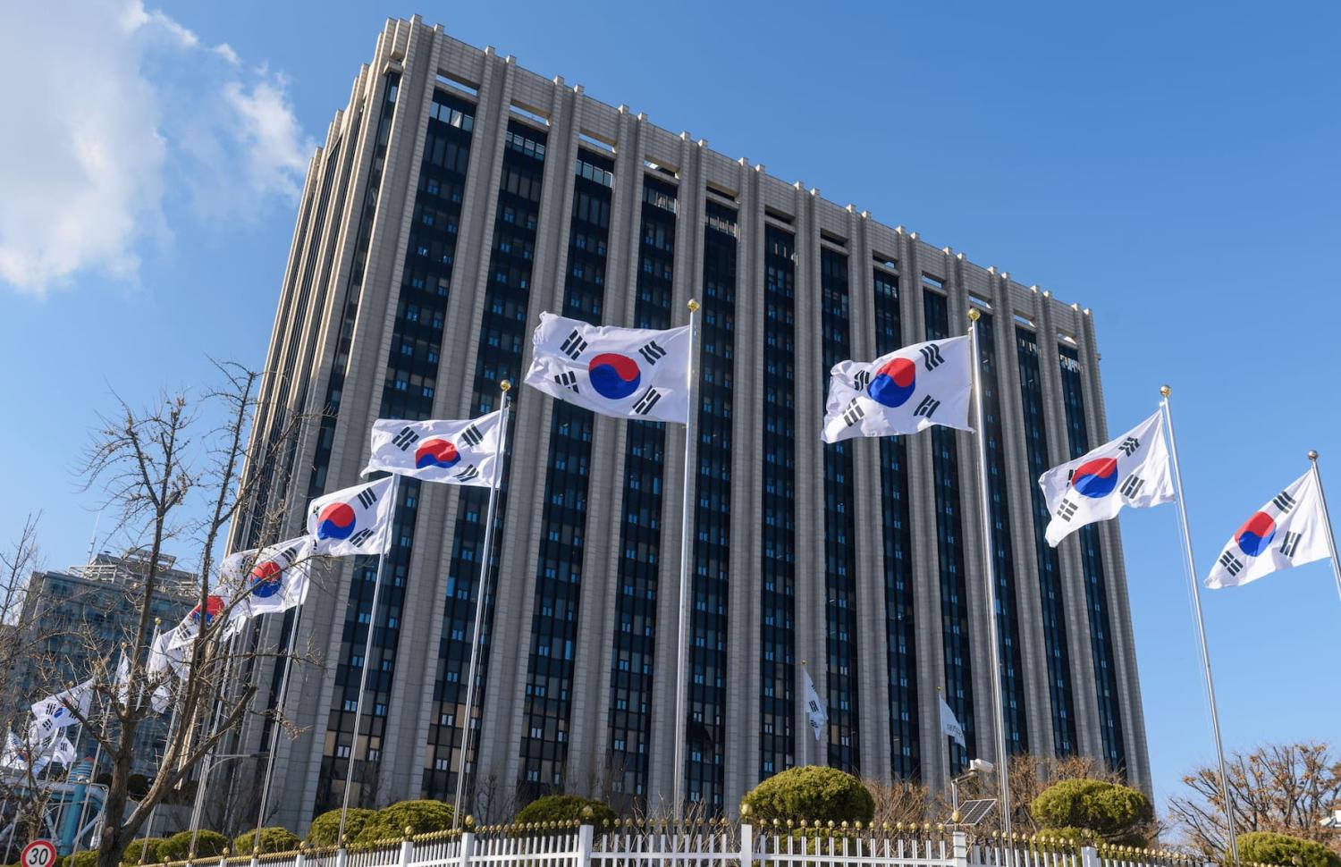 South Korean flags are flying in the wind at the government building in Seoul. The government building has the Prime Minister's Office, and now it is the office of the Acting President Han Deok-soo.