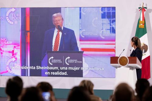 Mexico's President Claudia Sheinbaum watches a screen displaying a speech by U.S. President-elect Donald Trump, during her regular morning press conference, at the National Palace in Mexico City, Mexico, December 23, 2024.