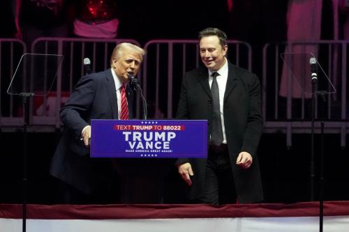 Elon Musk and President-elect Donald Trump are pictured speaking at the 'Make America Great Again Victory Rally' at the Capital One Arena in Washington.
