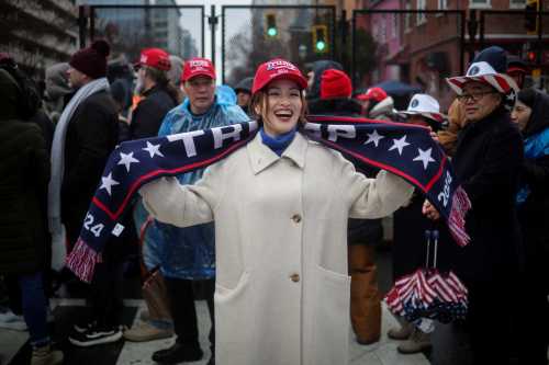 Grace Sun, from Shenzhen China, poses for a picture outside Capital One Arena, ahead of a rally for U.S. President-elect Donald Trump the day before he is scheduled to be inaugurated for a second term, in Washington, U.S., January 19, 2025.
