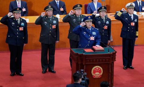 Newly elected vice chairman of the Central Military Commission Xu Qiliang (bottom) and (2nd row L to R) members of the Central Military Commission Zhang Shengmin and Li Zuocheng, vice chairman of the Central Military Commission Zhang Youxia, members of the Central Military Commission Wei Fenghe and Miao Hua, take an oath to the Constitution at the sixth plenary session of the National People's Congress (NPC) at the Great Hall of the People in Beijing, China March 18, 2018.