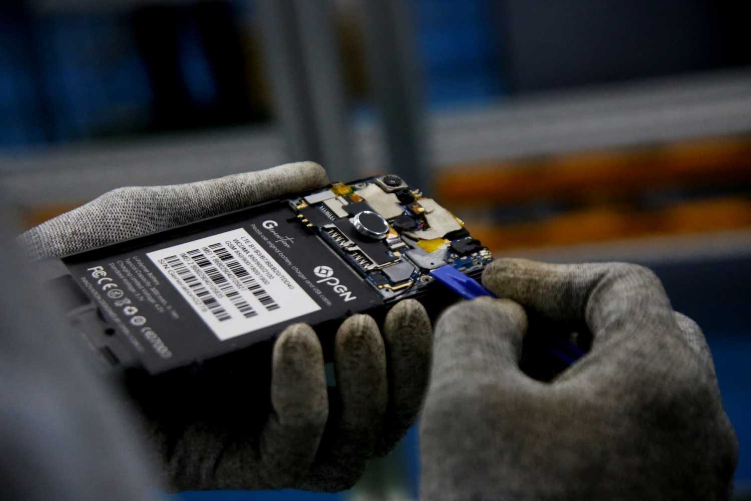 A worker manufactures Open G smartphones, which can speak local Ivorian languages, at a factory in Grand Bassam, Ivory Coast.