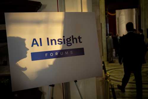 A sign for the Senate Artificial Intelligence Insight Forums is seen illuminated by sunlight outside the meeting room where experts gathered with lawmakers, at the U.S. Capitol, in Washington, D.C., on Tuesday, October 24, 2023.