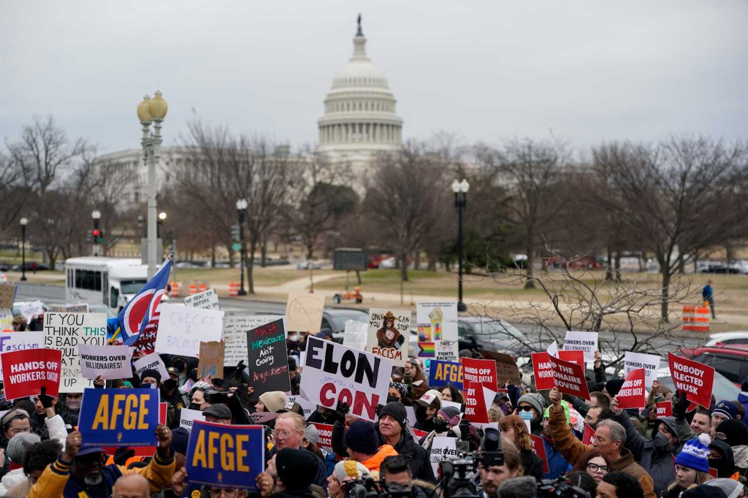Demonstrators rally during a protest against U.S. President Donald Trump and the actions he has taken in the first weeks of his presidency that pose threats to US democracy, outside of the Department of Labor (not pictured) in Washington, U.S., February 5, 2025.