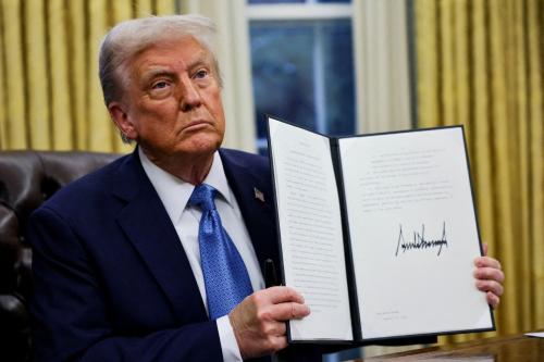 U.S. President Donald Trump holds a signed executive order in the Oval Office at the White House in Washington, U.S., January 31, 2025.