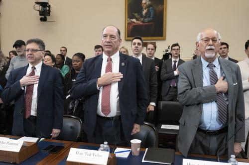 Image showing Max Primorac, former USAID official; former Rep. Ted Yoho (R-FL); and Andrew Natsios, former USAID administrator, recite the Pledge of Allegiance at a House Foreign Affairs Committee hearing, “The USAID Betrayal,” on Capitol Hill, Feb. 13, 2025.