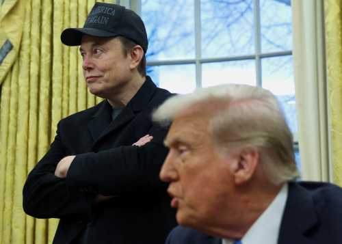 FILE PHOTO: Elon Musk listens to U.S. President Donald Trump speak in the Oval Office of the White House in Washington, D.C., U.S., February 11, 2025.