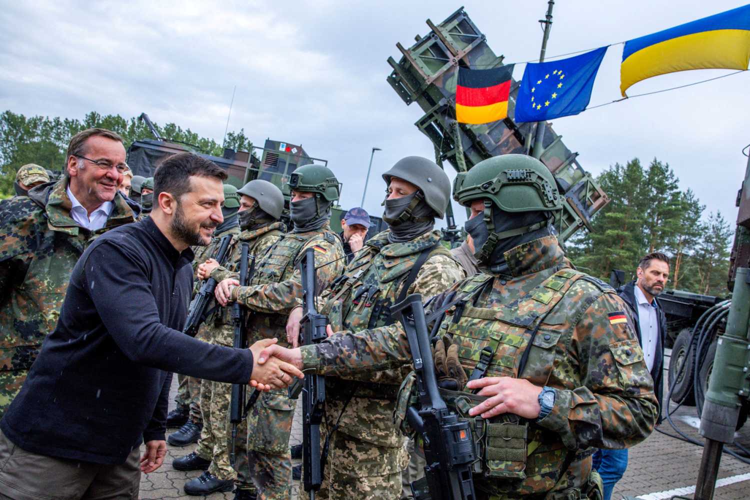 Ukrainian President Volodymyr Zelenskyy interacts with soldiers during his visit to a military training area to find out about the training of Ukrainian soldiers on the Patriot anti-aircraft missile system, at an undisclosed location, in Germany, June 11, 2024.
