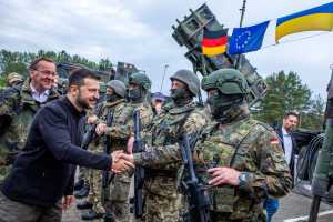 Ukrainian President Volodymyr Zelenskyy interacts with soldiers during his visit to a military training area to find out about the training of Ukrainian soldiers on the Patriot anti-aircraft missile system, at an undisclosed location, in Germany, June 11, 2024.