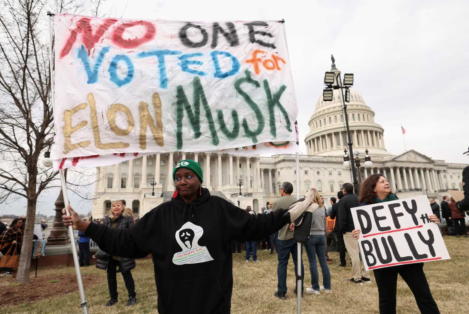 Anti-Trump demonstrators protest outside the U.S. Capitol, as Republicans prepare to vote on U.S. President Trump's tax-cut agenda, in Washington, D.C., U.S., February 25, 2025. REUTERS/Kevin Lamarque