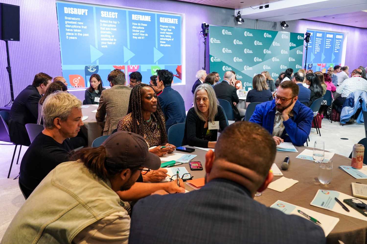 17 Rooms participants, including (left to right) Hafsat Abiola, Wendy Kopp, and Jordan Sandman, engage in small group discussions during the September community gathering.