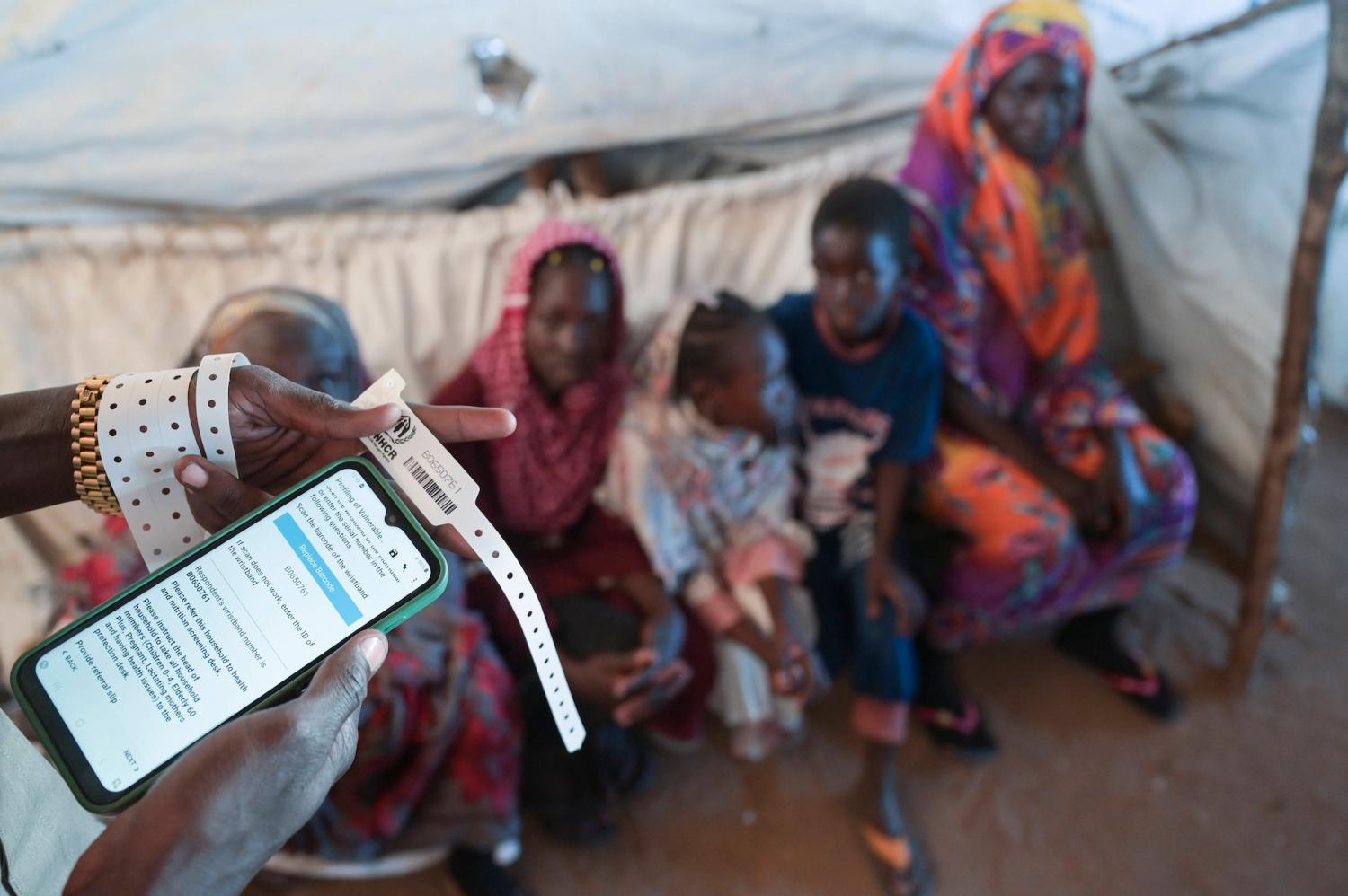 At a UNHCR transit center in Sudan, refugees receive digital registration via unique ID codes, which enables humanitarian assistance and safe relocation. IMAGO/Joerg Boethling via Reuters Connect