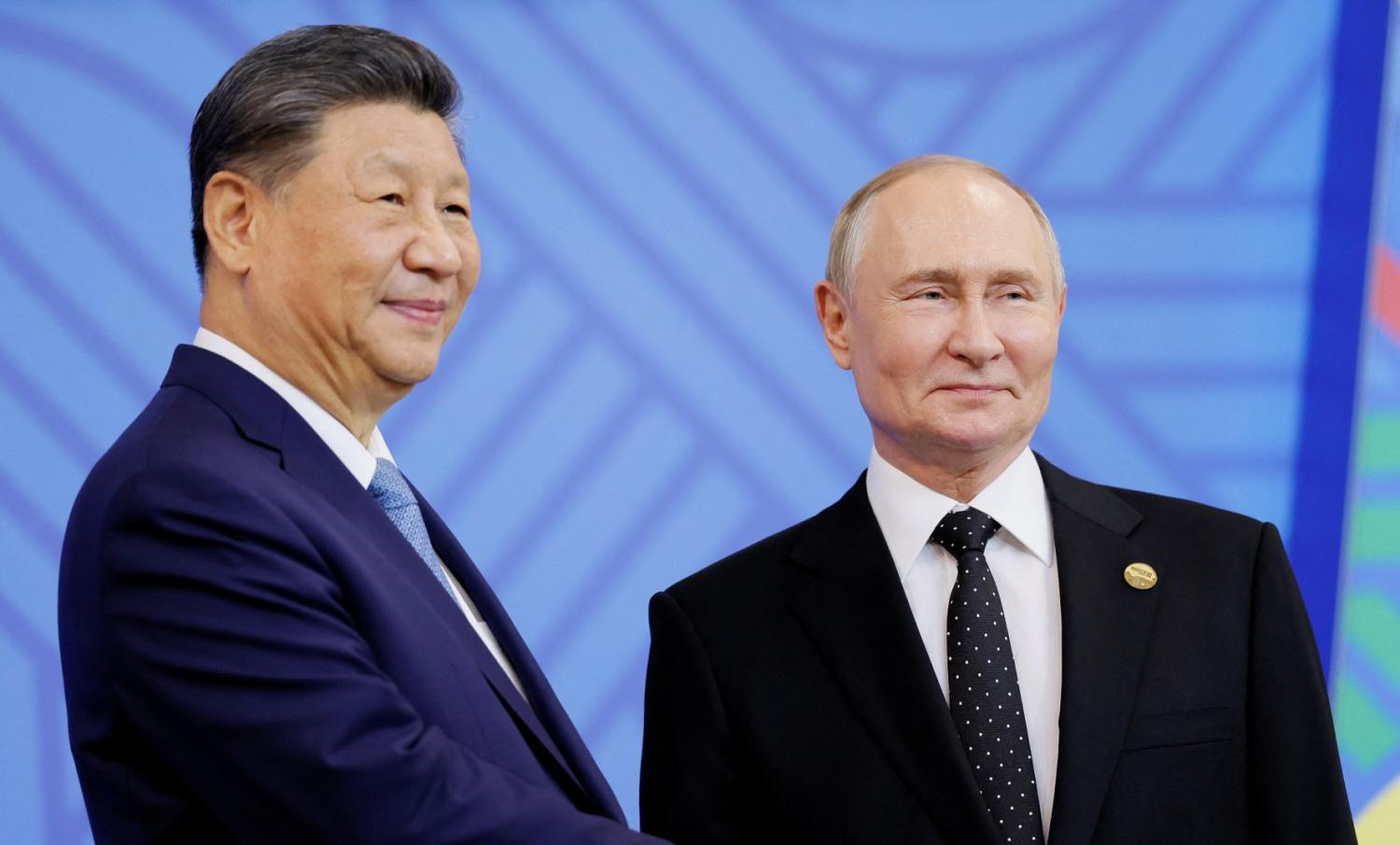 Russian President Vladimir Putin greets Chinese President Xi Jinping during an official welcoming ceremony for delegations' heads at the BRICS summit in Kazan, Russia October 23, 2024.