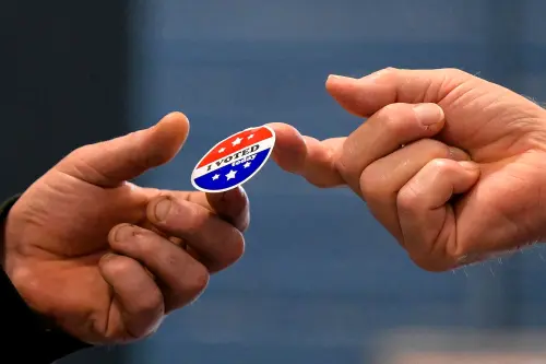 A voter receives a sticker after casting his ballot at New Begin Hall during the 2024 U.S. presidential election on Election Day in Gray, Maine, U.S., on November 5, 2024.