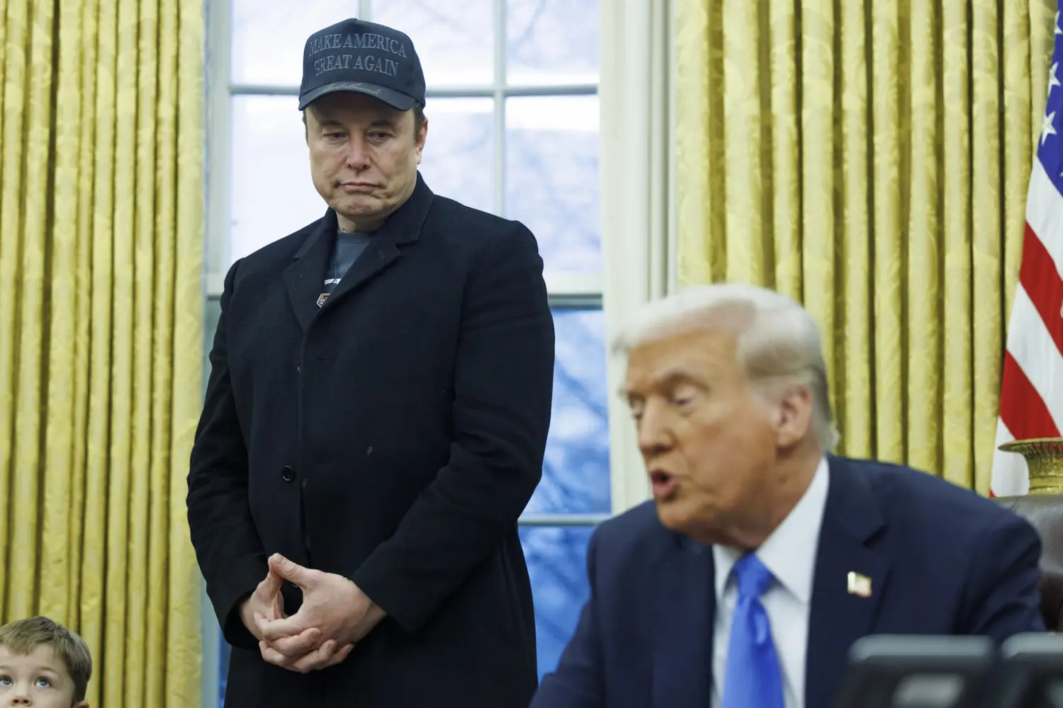 Elon Musk looks on as US President Donald Trump gives remarks to the media, in the Oval Office of the White House in Washington, D.C. on February 11, 2025.