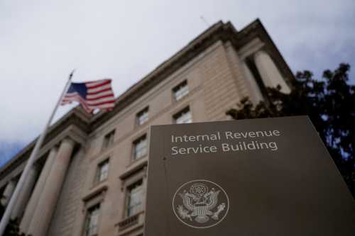 A flag waves outside the International Revenue Service Building after it was reported the U.S. Internal Revenue Service (IRS) is preparing to fire thousands of workers in the coming days, in Washington, D.C., U.S., February 18, 2025.