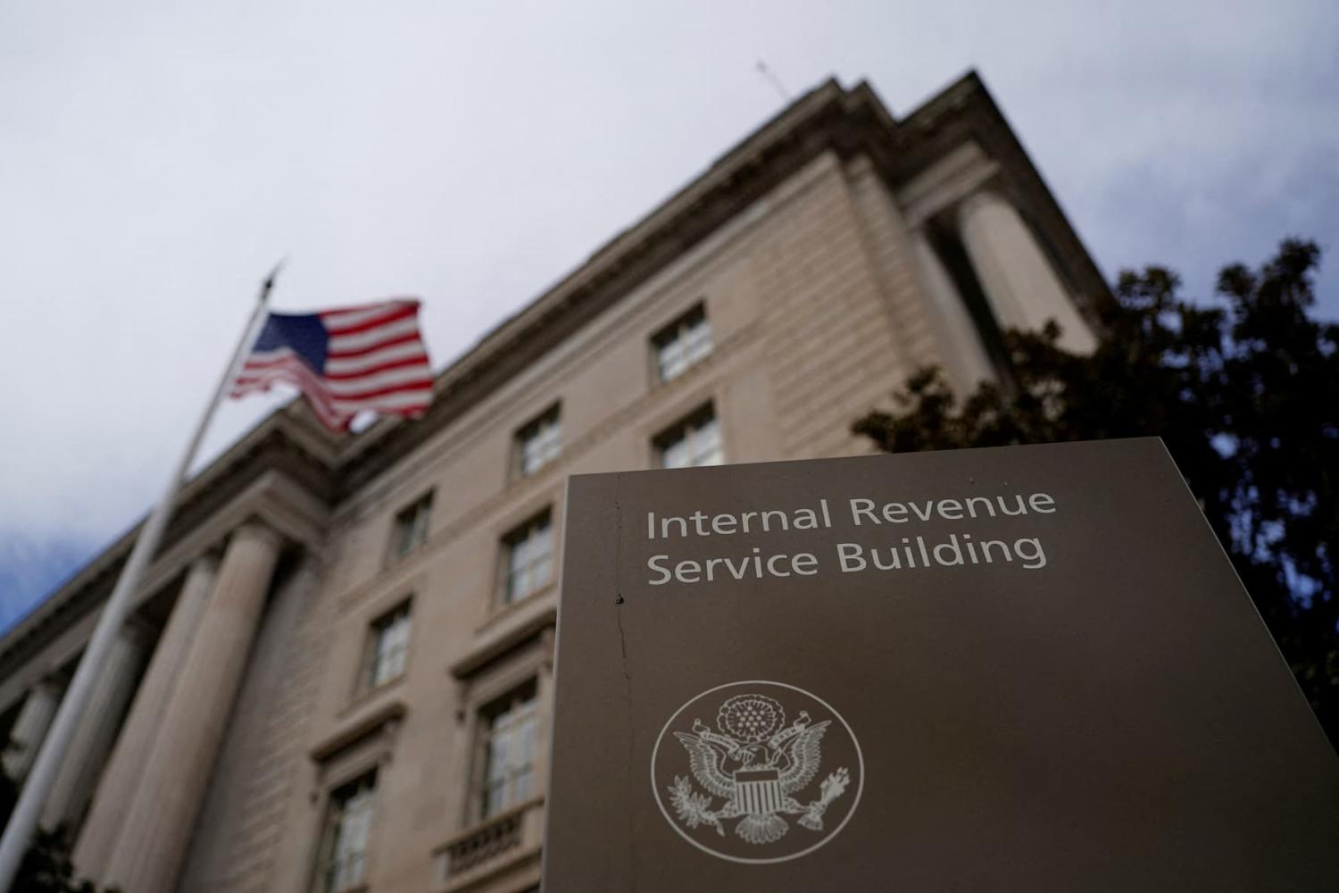 A flag waves outside the International Revenue Service Building after it was reported the U.S. Internal Revenue Service (IRS) is preparing to fire thousands of workers in the coming days, in Washington, D.C., U.S., February 18, 2025.
