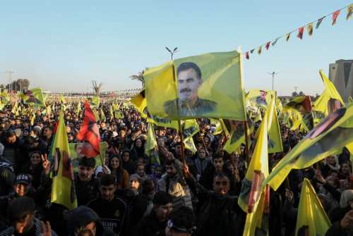 Syrian Kurds gather as they hold flags after Turkey's jailed militant leader Abdullah Ocalan called on his Kurdistan Workers Party (PKK) to lay down its arms on Thursday, a move that could end its 40-year conflict with Ankara and have far-reaching political and security consequences for the region, in Hasakah, Syria February 27, 2025.