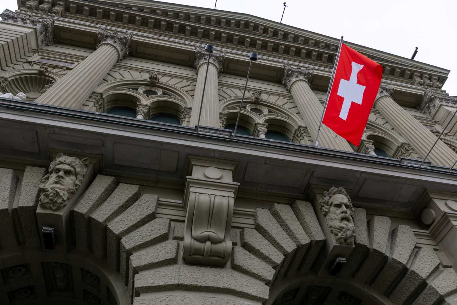 A Swiss flag hangs at the Swiss Parliament building (Bundeshaus) in Bern, Switzerland, March 12, 2025.