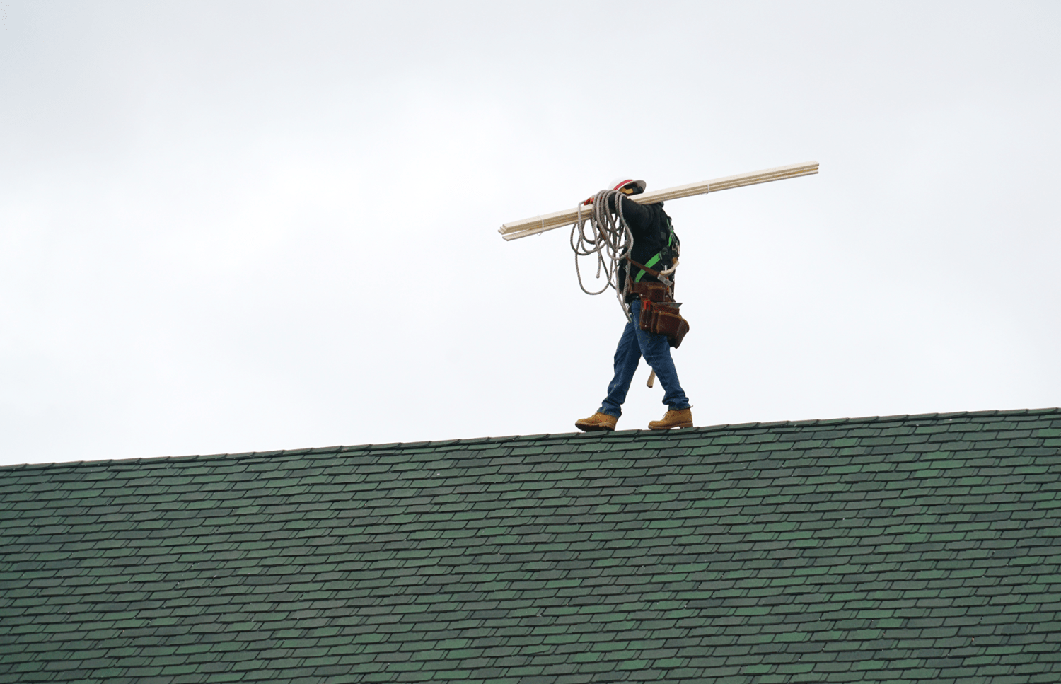 A construction worker on a roof representing work permits