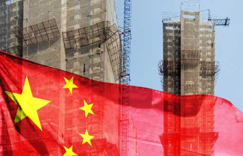 Chinese flag in front a construction site.