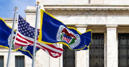 Washington, US, March 2023: flags of the Federal Reserve and the United States waving with the Eccles Building in the background.